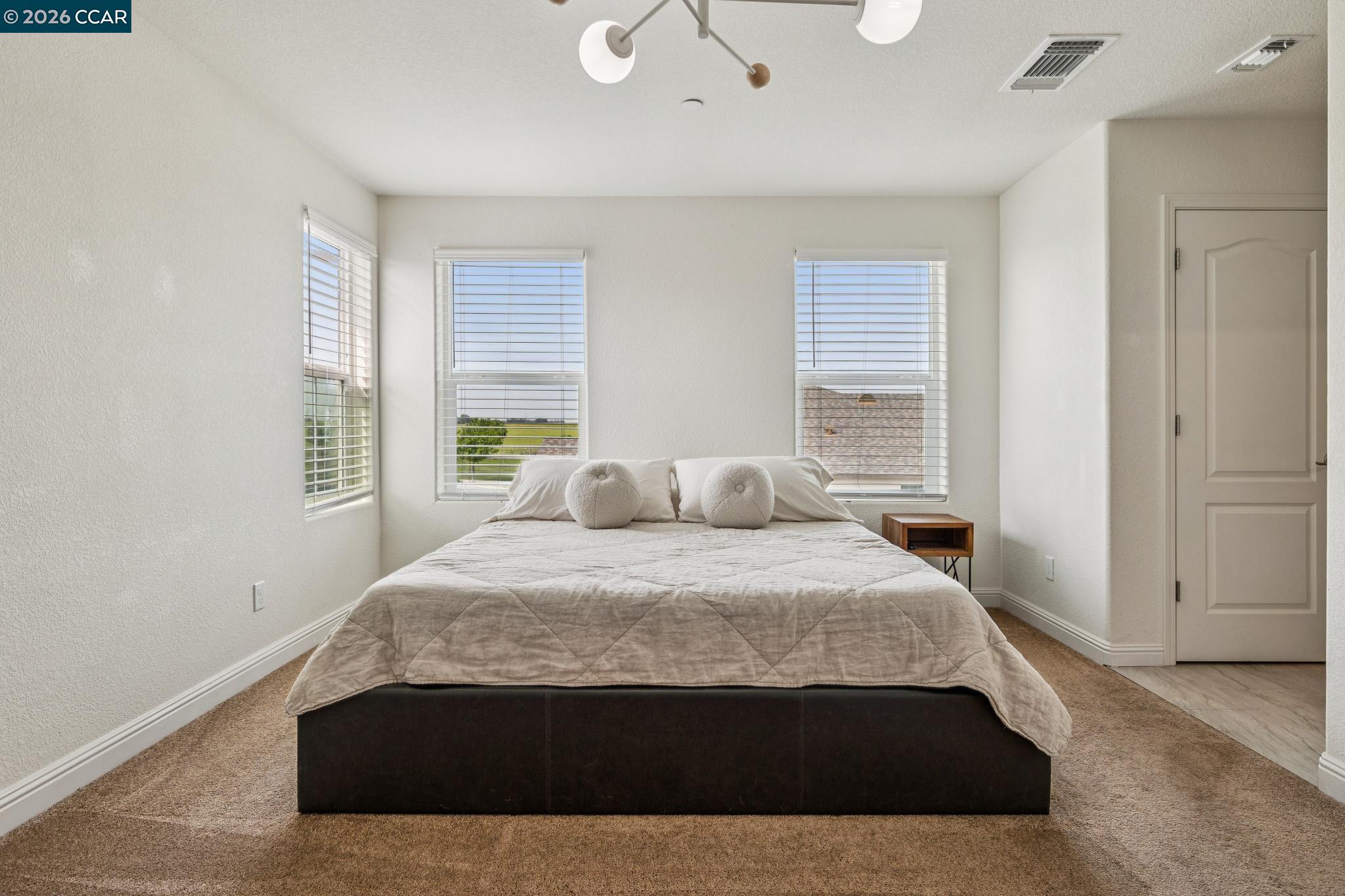 4748 Beacon Way Rio Vista, CA 94571 - Photo 16 of 35 a large bed sitting in a bedroom next to a window