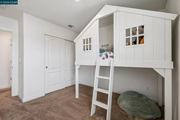 a view of a livingroom with furniture and staircase