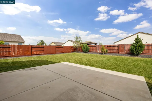 a view of a house with a big yard and large trees