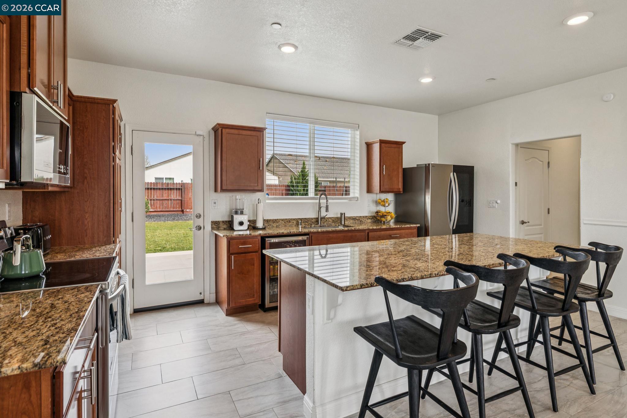 4748 Beacon Way Rio Vista, CA 94571 - Photo 9 of 35 a kitchen with refrigerator and chairs