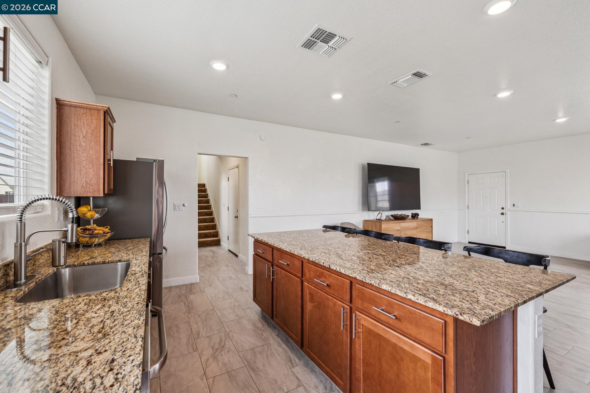 4748 Beacon Way Rio Vista, CA 94571 - Photo 10 of 35 a kitchen with stainless steel appliances granite countertop a sink stove and refrigerator