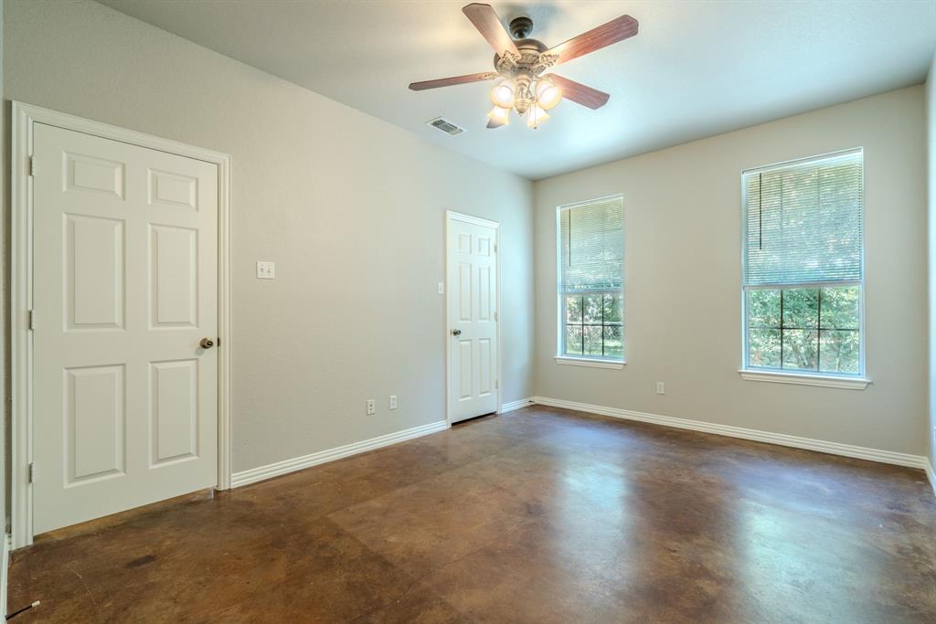 403 Summer Tree Lane Springtown, TX 76082 - Photo 8 of 19 Primary bedroom featuring a ceiling fan, fresh paint and stained concrete flooring