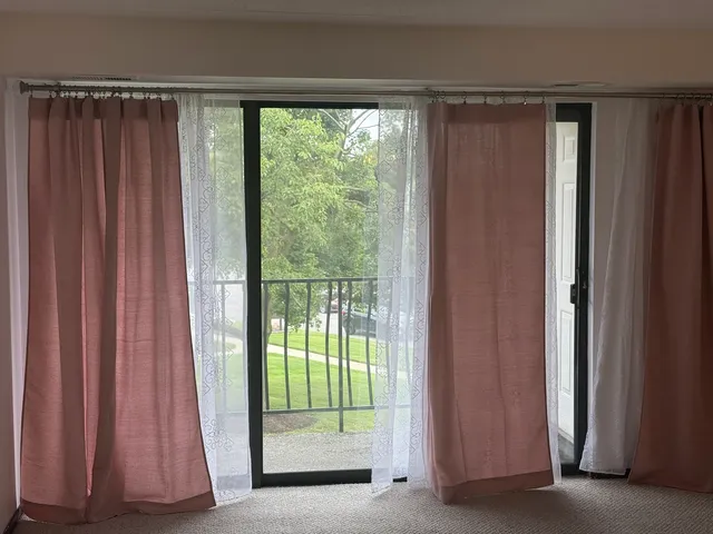 a view of a room that has a bed and a window