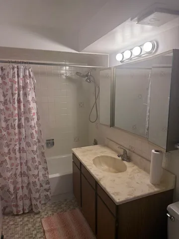 a bathroom with a sink vanity granite and a mirror
