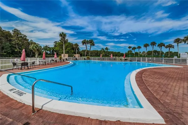 a view of a swimming pool with lawn chairs
