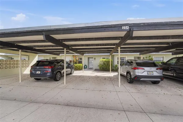 a view of parking garage with cars parked