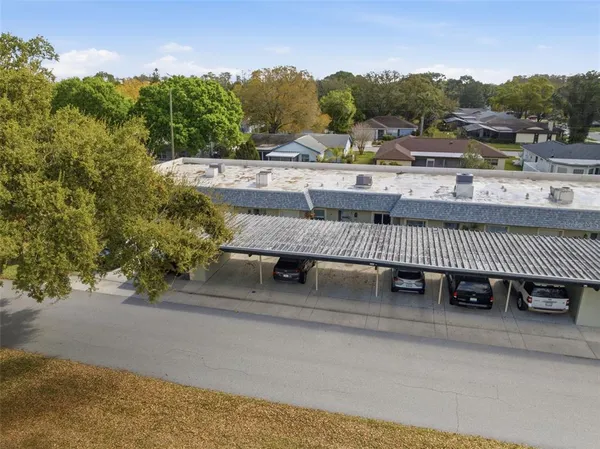 an aerial view of residential houses with outdoor space and swimming pool
