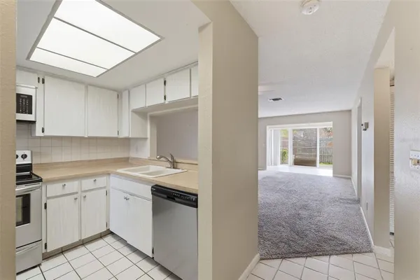 a kitchen with a refrigerator stove and sink