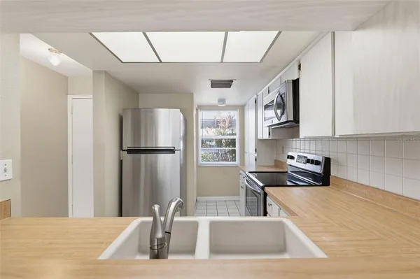 a kitchen with a sink appliances and cabinets