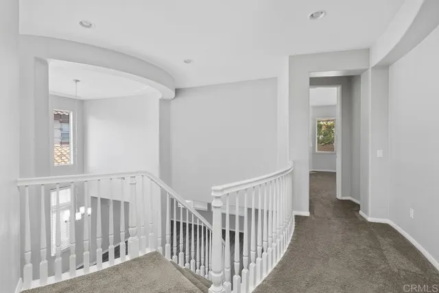 a view of a hallway with wooden floor and entryway
