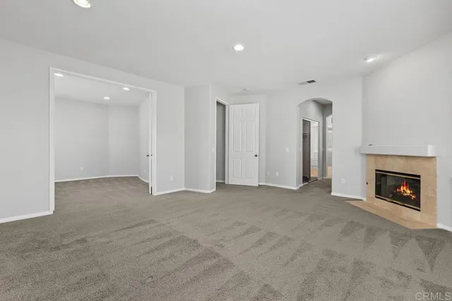 a view of an empty room with a fireplace