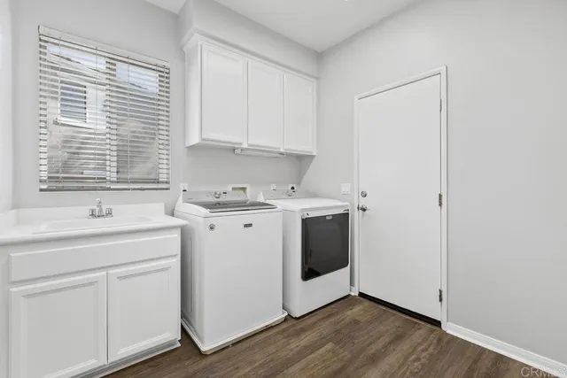 a view of a white stove cabinets and a window