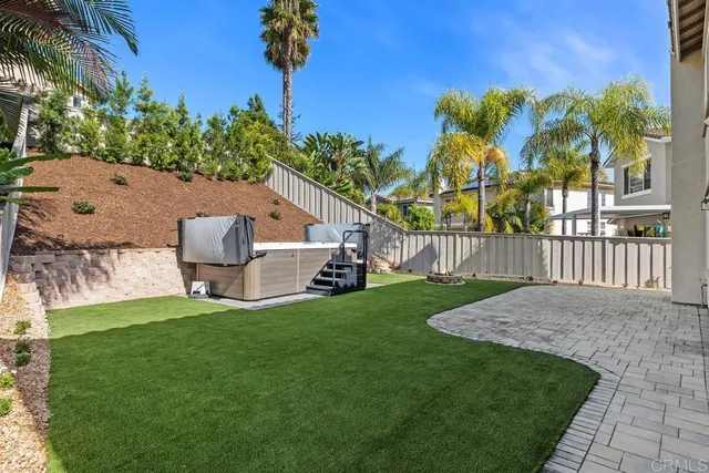 a view of a house with a yard and a patio