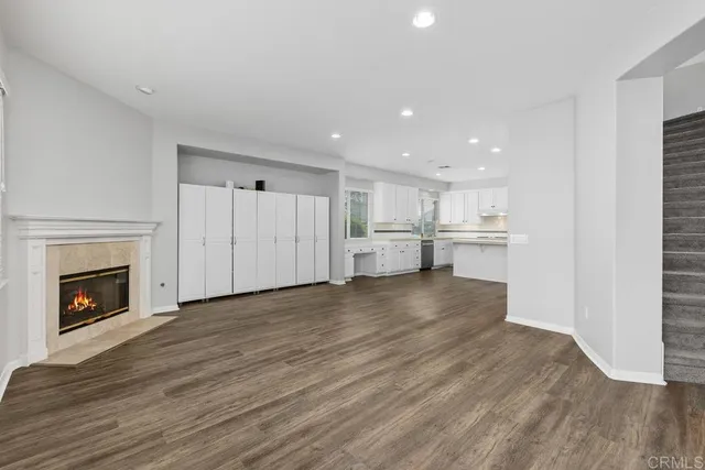 a view of kitchen with wooden floor and a fireplace