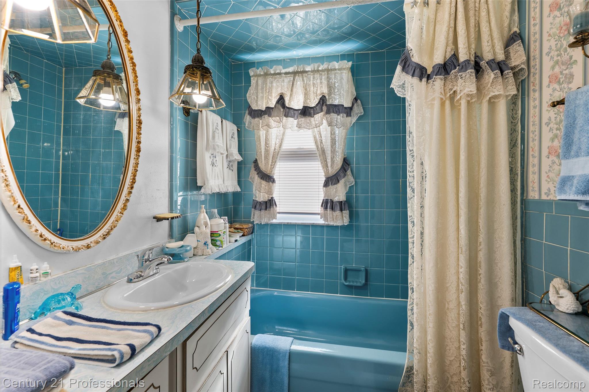 12178 Stephens Road Warren, MI 48089 - Photo 22 of 34 Bathroom featuring shower / tub combo with curtain, vanity, and tile walls
