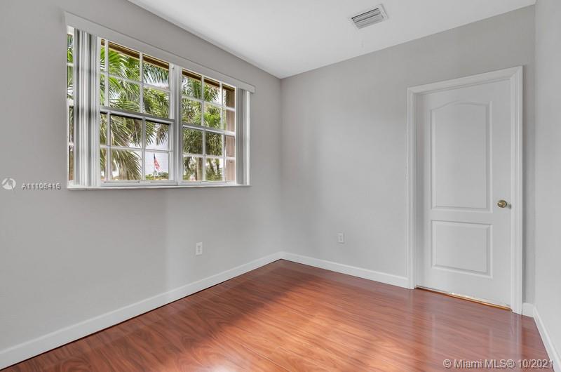 4131 Southwest 154th Court Miami, FL 33185 - Photo 14 of 36 an empty room with wooden floor and windows