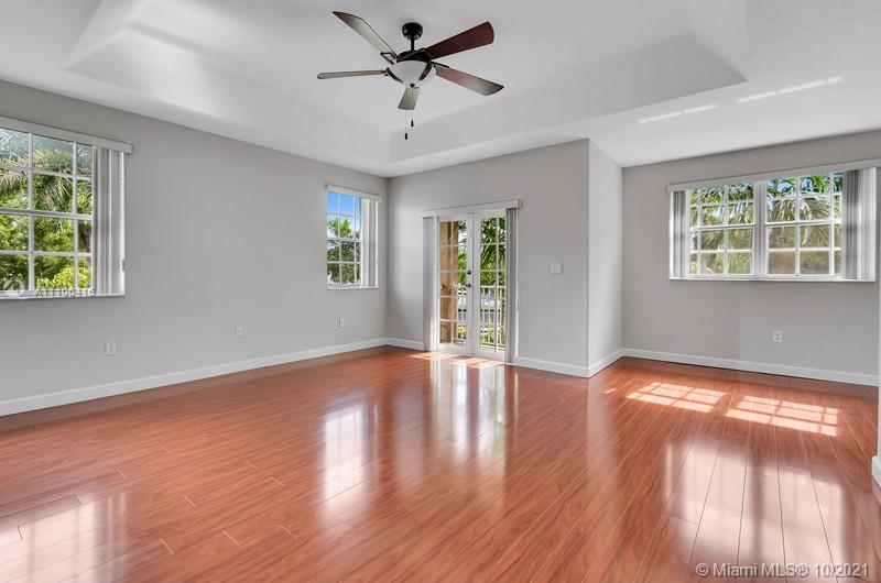 4131 Southwest 154th Court Miami, FL 33185 - Photo 15 of 36 a view of an empty room with wooden floor and a window