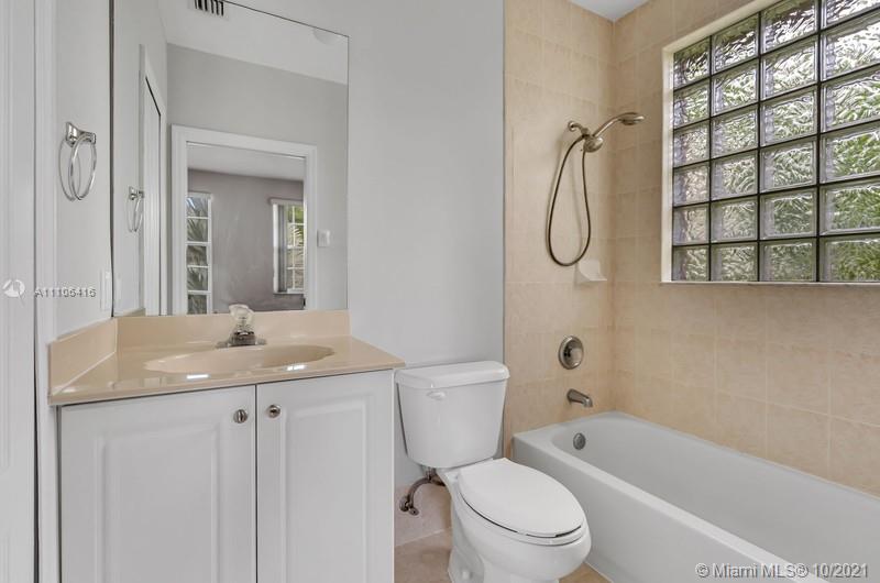 4131 Southwest 154th Court Miami, FL 33185 - Photo 18 of 36 a bathroom with a granite countertop toilet sink and mirror