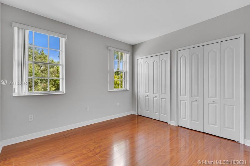 4131 Southwest 154th Court Miami, FL 33185 - Photo 19 of 36 an empty room with wooden floor closet and windows