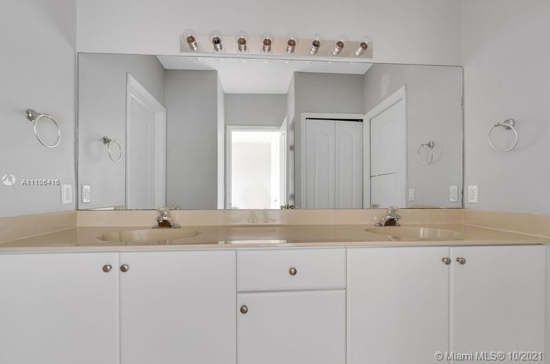 4131 Southwest 154th Court Miami, FL 33185 - Photo 20 of 36 a bathroom with a granite countertop sink and a mirror
