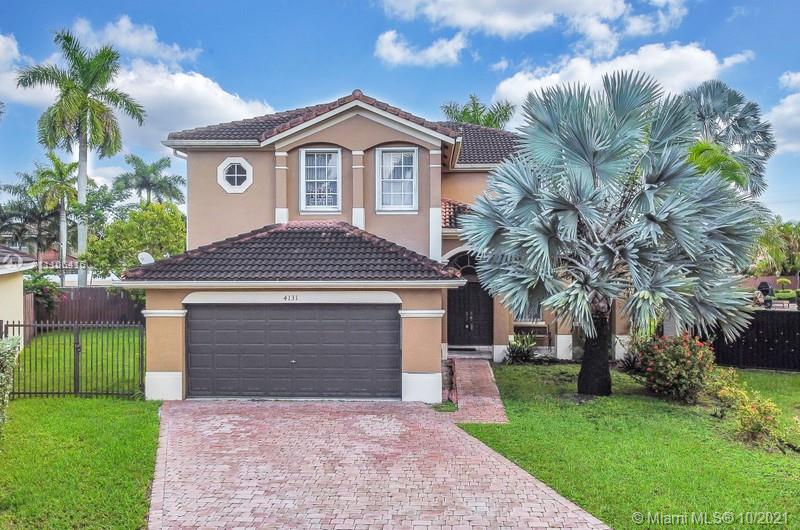 4131 Southwest 154th Court Miami, FL 33185 - Photo 2 of 36 a front view of a house with a garden and trees