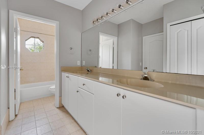 4131 Southwest 154th Court Miami, FL 33185 - Photo 21 of 36 a bathroom with a tub a sink and mirror