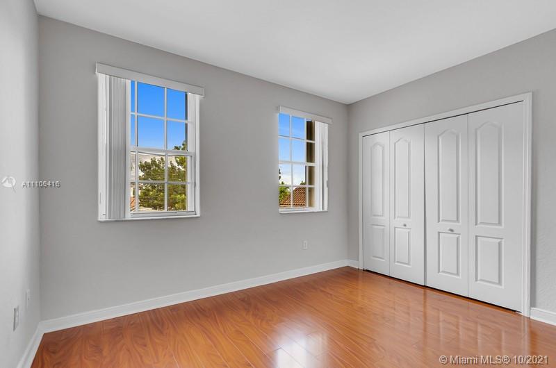 4131 Southwest 154th Court Miami, FL 33185 - Photo 23 of 36 a view of an empty room with window and wooden floor