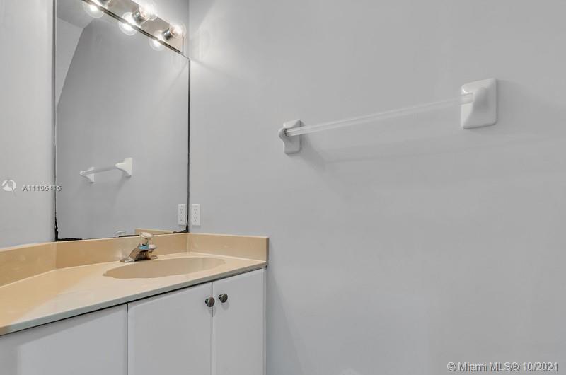4131 Southwest 154th Court Miami, FL 33185 - Photo 24 of 36 a bathroom with a sink and a mirror