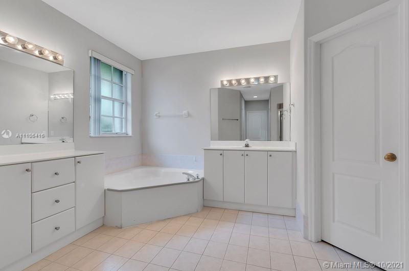 4131 Southwest 154th Court Miami, FL 33185 - Photo 26 of 36 a bathroom with a tub sink and mirror