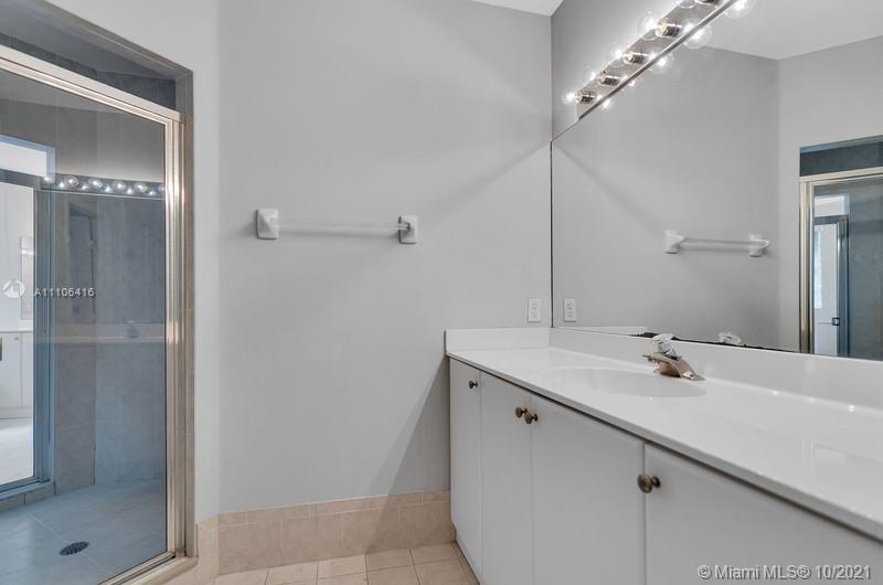 4131 Southwest 154th Court Miami, FL 33185 - Photo 27 of 36 a bathroom with a sink and mirror