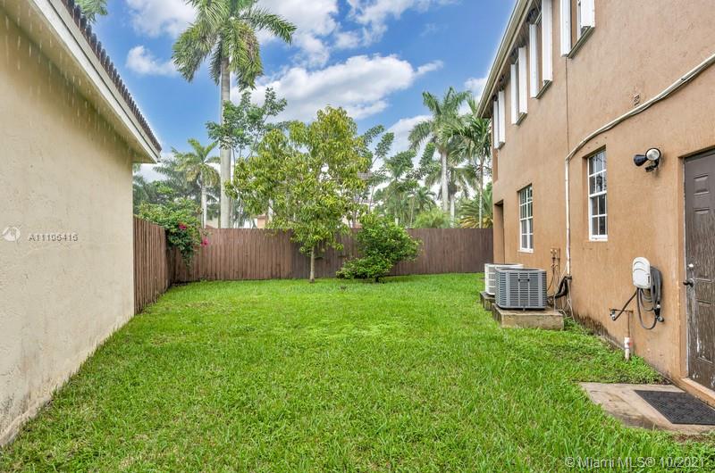 4131 Southwest 154th Court Miami, FL 33185 - Photo 30 of 36 a view of a backyard with plants and a large tree