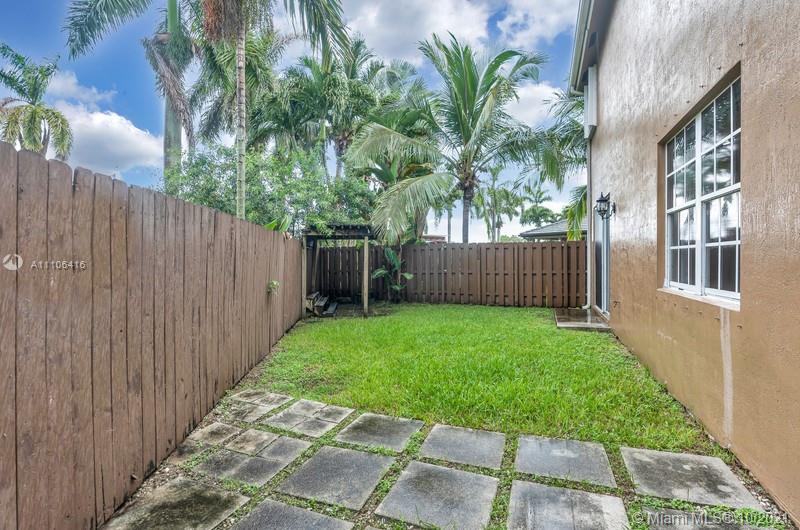 4131 Southwest 154th Court Miami, FL 33185 - Photo 31 of 36 a view of a house with a yard and wooden fence