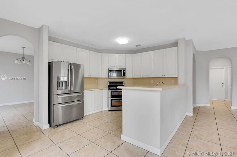 4131 Southwest 154th Court Miami, FL 33185 - Photo 6 of 36 a kitchen with cabinets stainless steel appliances and a counter space