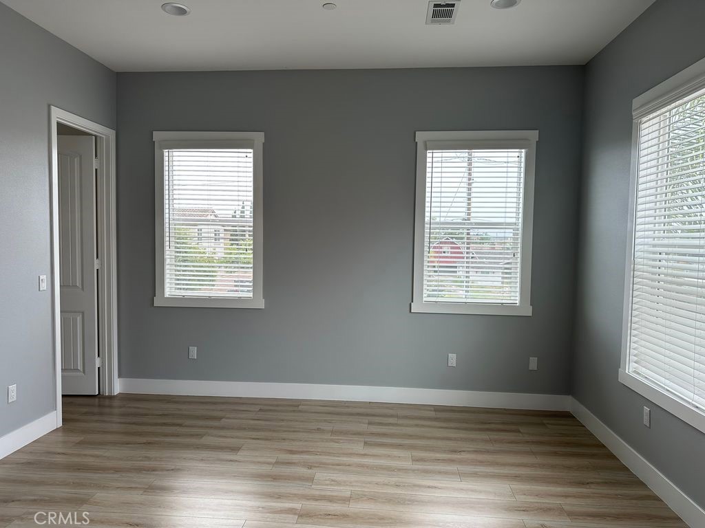 31913 St Joseph Lane Stanton, CA 90680 - Photo 3 of 12 a view of an empty room with wooden floor and a window