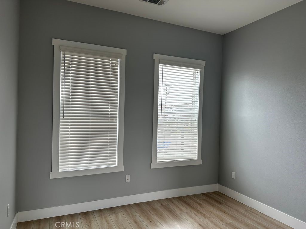 31913 St Joseph Lane Stanton, CA 90680 - Photo 4 of 12 a view of an empty room with wooden floor and a window
