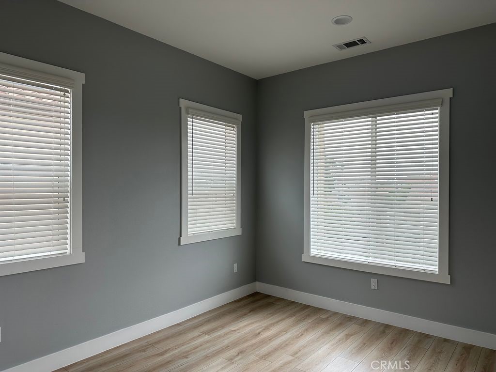 31913 St Joseph Lane Stanton, CA 90680 - Photo 5 of 12 a view of an empty room with wooden floor and a window