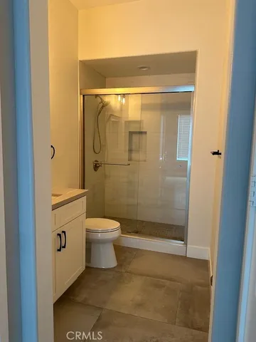 a bathroom with a toilet and shower