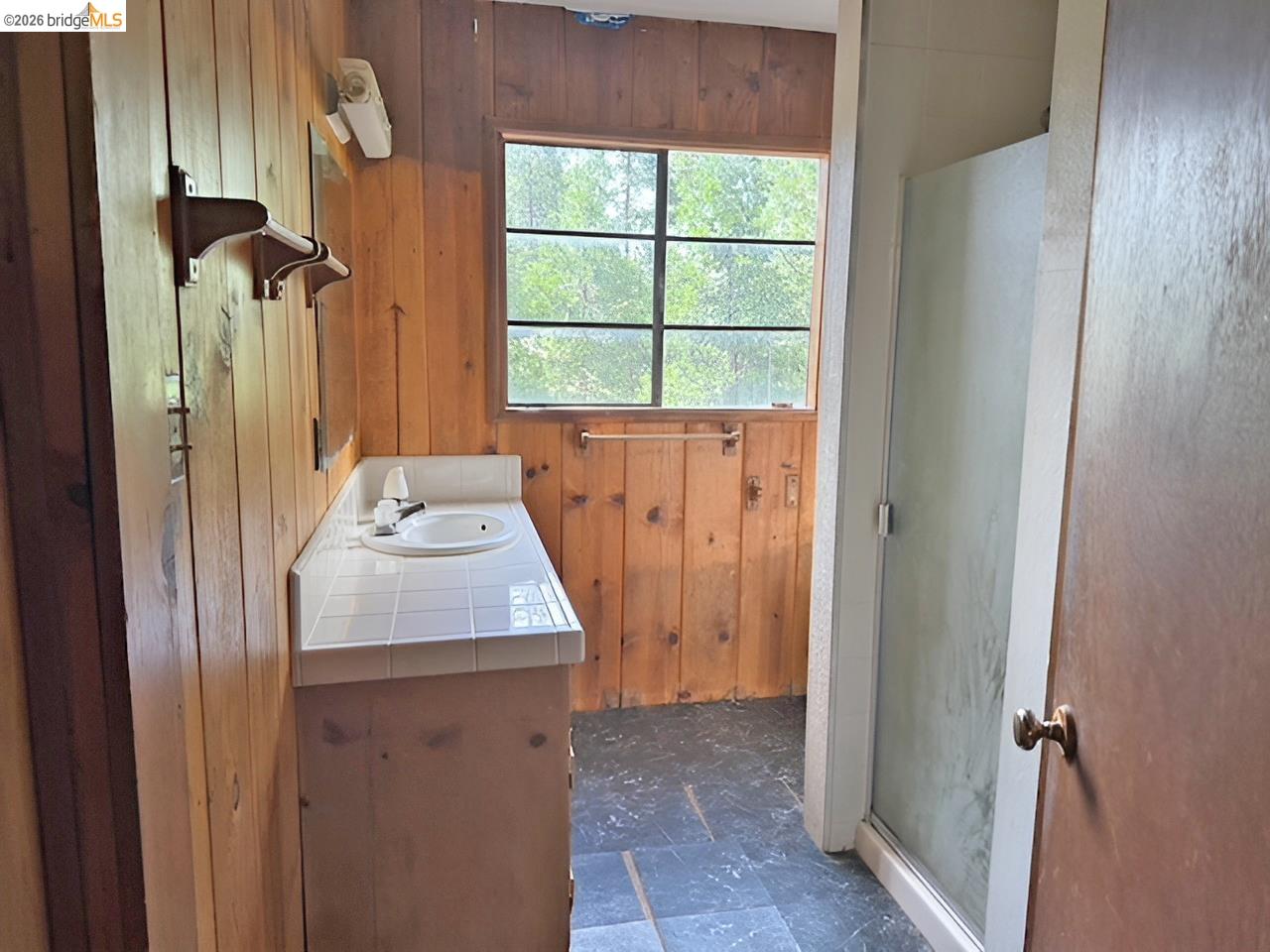 20693 Muheli Road Mi Wuk Village, CA 95346 - Photo 12 of 15 a bathroom with a sink vanity and window