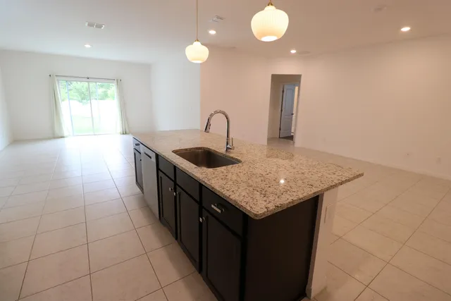 a kitchen with stainless steel appliances granite countertop a sink a counter top space and cabinets