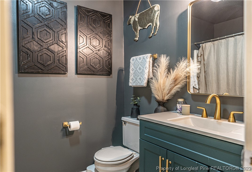 3 Red Cedar Lane Pinehurst, NC 28374 - Photo 13 of 20 a bathroom with a toilet sink and mirror