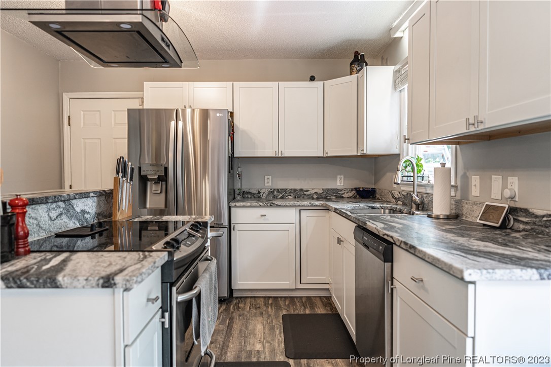 3 Red Cedar Lane Pinehurst, NC 28374 - Photo 6 of 20 a kitchen with a sink stove and refrigerator