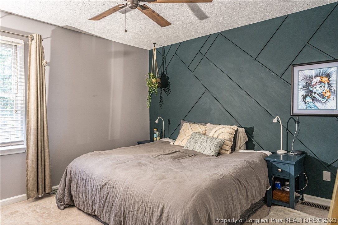 3 Red Cedar Lane Pinehurst, NC 28374 - Photo 9 of 20 a bedroom with a bed and a flat tv screen