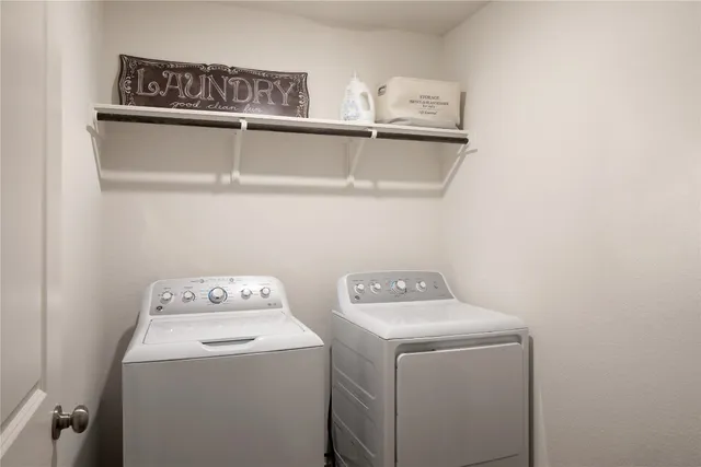a living room with furniture kitchen and a large window