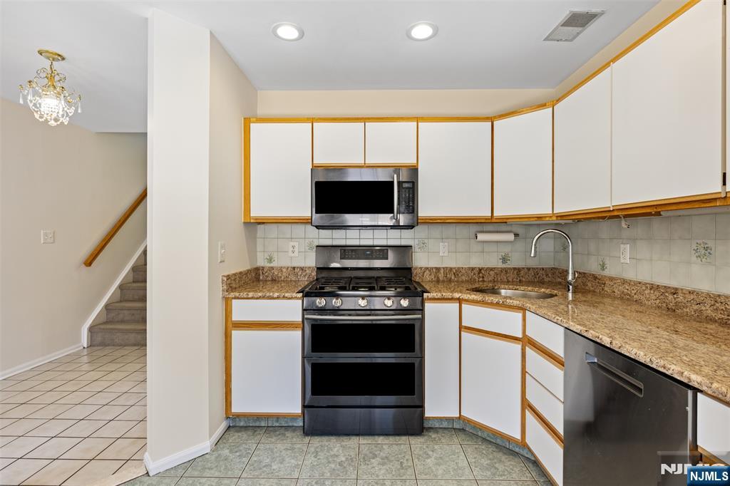 2384 Quill Court Mahwah, NJ 07430 - Photo 11 of 31 a kitchen with a stove and a microwave