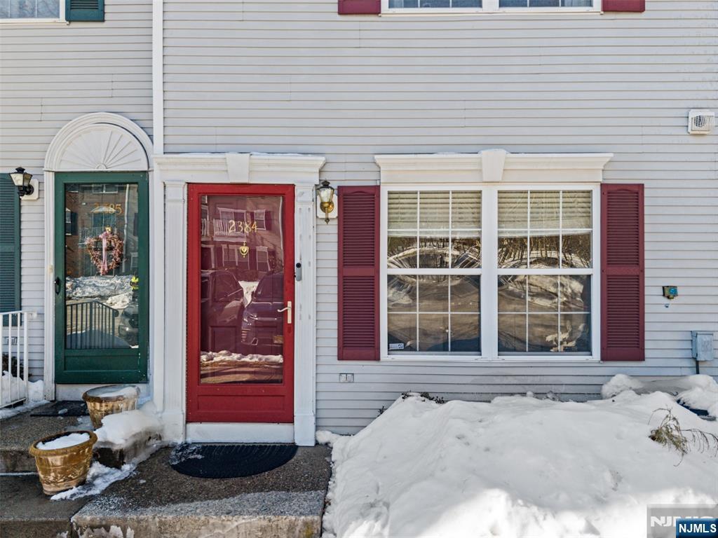 2384 Quill Court Mahwah, NJ 07430 - Photo 2 of 31 a front view of a building with a potted plant and a window