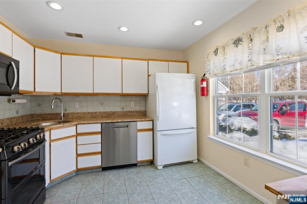 2384 Quill Court Mahwah, NJ 07430 - Photo 10 of 31 a kitchen with stainless steel appliances granite countertop a refrigerator and a stove top oven