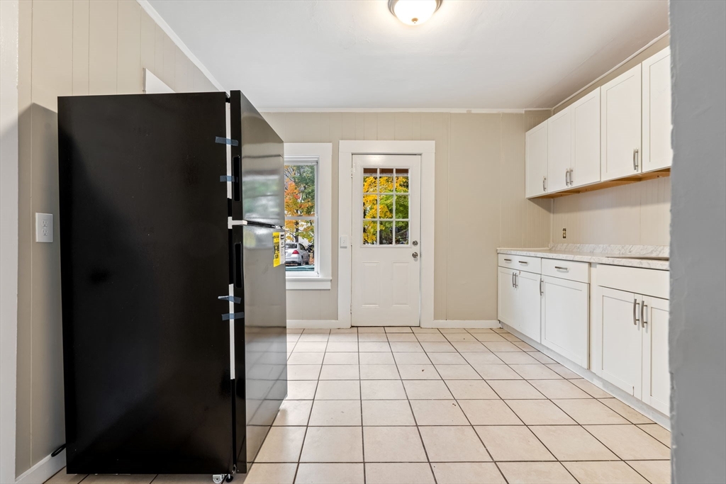 14-24 C Street, Unit 14 Northbridge, MA 01588 - Photo 12 of 25 a view of a kitchen with white cabinets and refrigerator