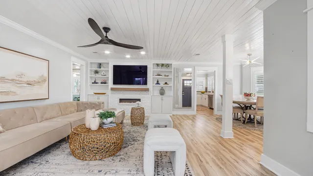a living room with furniture wooden floor and a view of kitchen