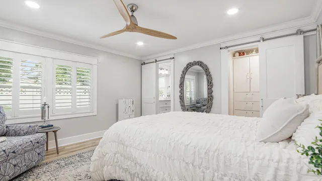 a bedroom with a large bed and a window