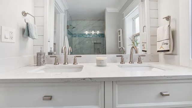 a bathroom with double vanity sink and a mirror